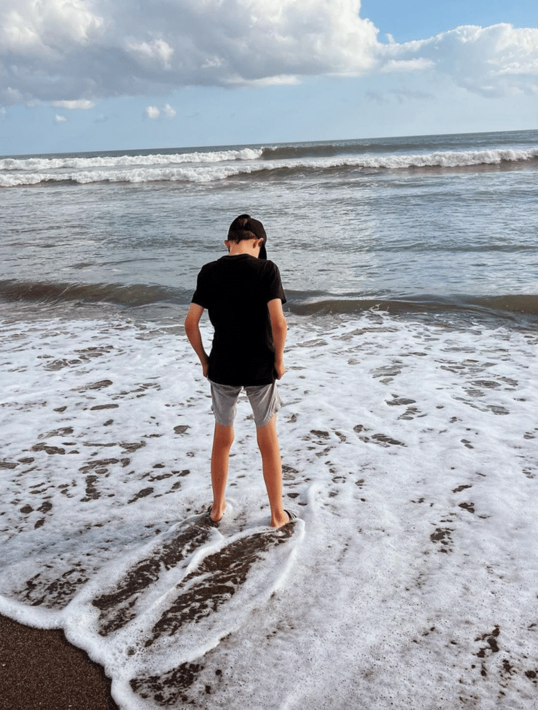 Boy in the waves in Bali beach